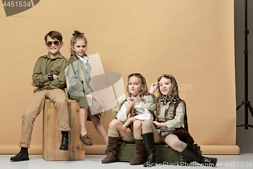 Image of The group of beautiful girls and boys on a pastel background