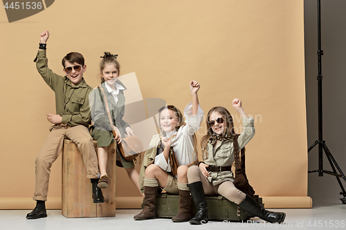 Image of The group of beautiful girls and boys on a pastel background