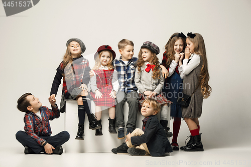 Image of The group of beautiful girls and boys on a pastel background