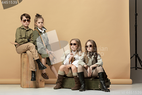 Image of The group of beautiful girls and boys on a pastel background