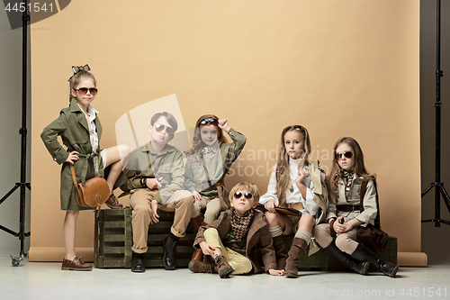 Image of The group of beautiful girls and boys on a pastel background