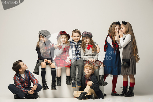 Image of The group of beautiful girls and boys on a pastel background