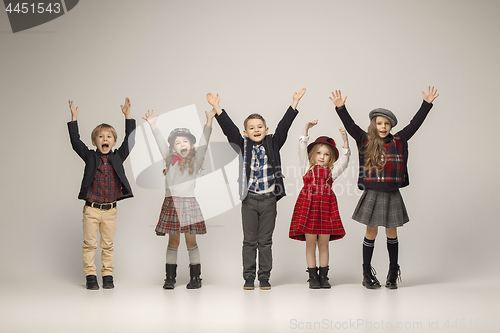 Image of The group of beautiful girls and boys on a pastel background