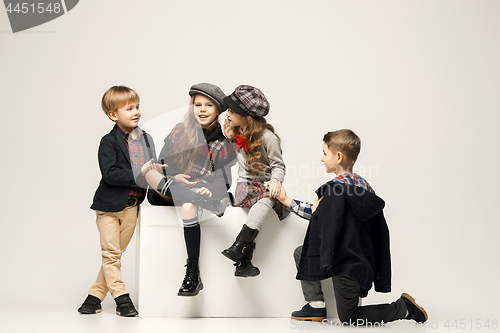 Image of The group of beautiful girls and boys on a pastel background