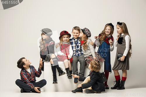 Image of The group of beautiful girls and boys on a pastel background