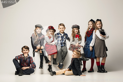 Image of The group of beautiful girls and boys on a pastel background