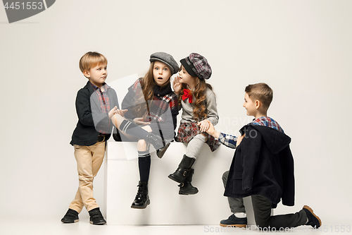 Image of The group of beautiful girls and boys on a pastel background