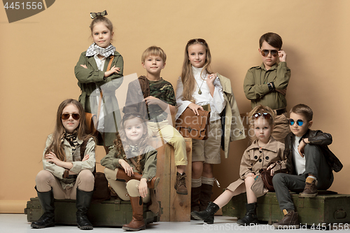 Image of The group of beautiful girls and boys on a pastel background