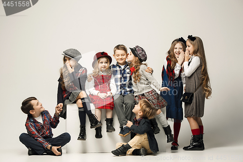 Image of The group of beautiful girls and boys on a pastel background