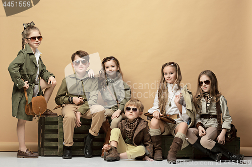 Image of The group of beautiful girls and boys on a pastel background