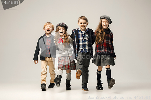 Image of The group of beautiful girls and boys on a pastel background