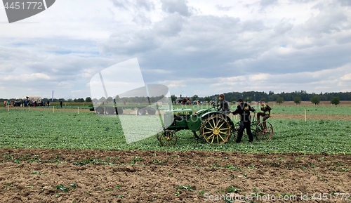 Image of Children learn how to use an old tractor and plow during the World Ploughing Competition in Germany 2018