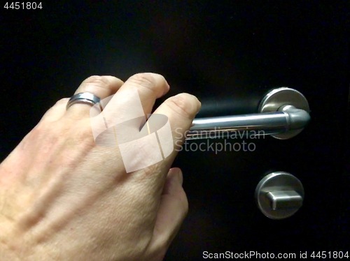 Image of hand approaching door knob