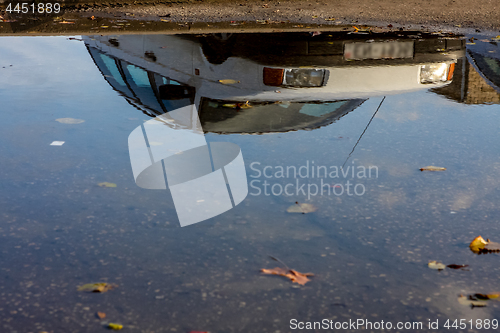 Image of Car reflected in puddle