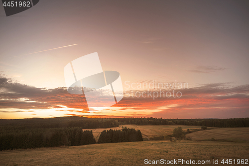 Image of Sunset over a rural landscape with dry plains