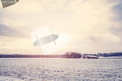 Image of Rural winter landscape with a red barn