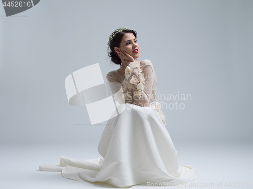 Image of young bride sitting in a wedding dress