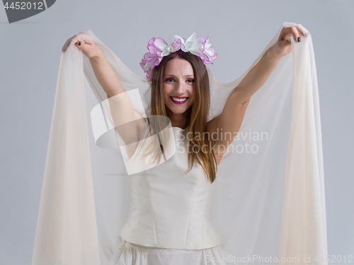 Image of young bride in a wedding dress with a veil