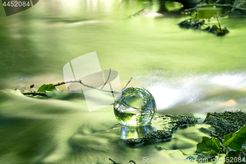 Image of Crystal ball in a river in the spring