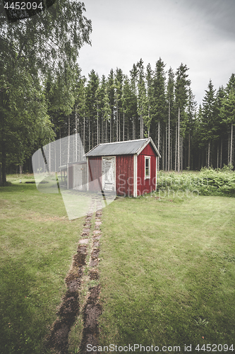 Image of Trail leading up to a small red cabin