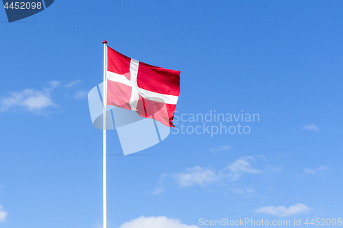 Image of The danish flag in red and white waving in the wind