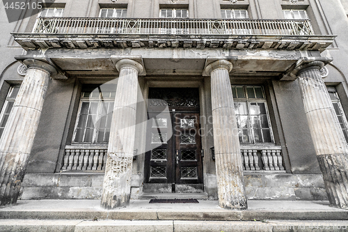 Image of Greek pillar building with weathered windows