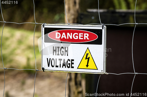 Image of High voltage sign on a fence