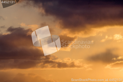 Image of Colorful sunset with fluffy clouds in the sky