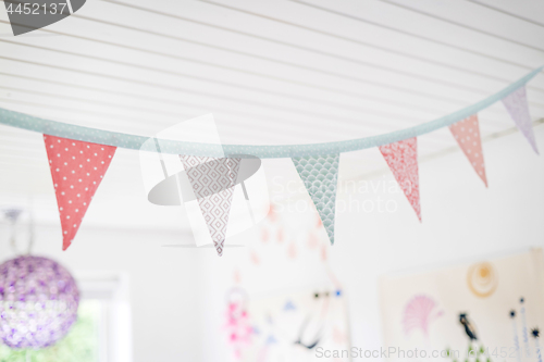 Image of Colorful birthday flags in kids playroom