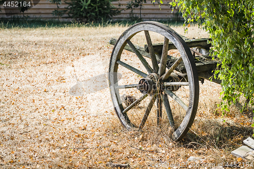 Image of Old wagon wheel on a carriage