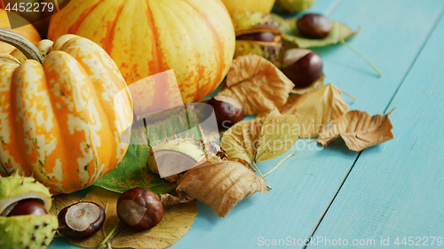 Image of Pumpkins decorated with chestnuts and leaves