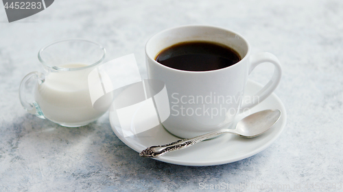 Image of Cup of coffee and pitcher of milk