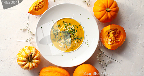 Image of Pumpkin soup in plate with vegetables around