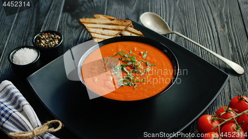 Image of Tomato soup in bowl with crisp bread