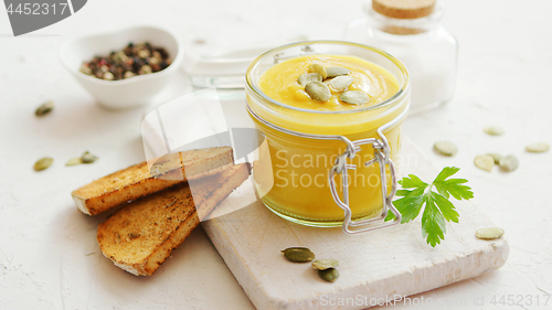 Image of Pumpkin soup in glass jar with bread