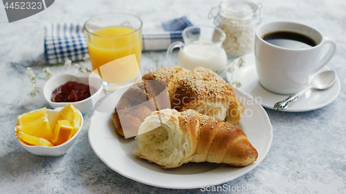 Image of Served breakfast with drinks and croissant