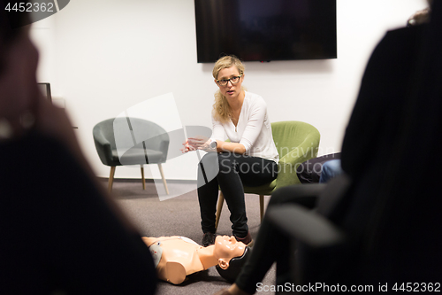 Image of Instructor teaching first aid cardiopulmonary resuscitation course and use of automated external defibrillator on CPR workshop.