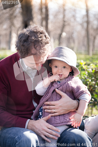 Image of Father with cheerful child in the park.