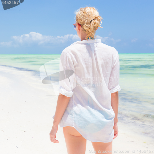 Image of Happy woman enjoying, relaxing joyfully in summer on tropical beach.