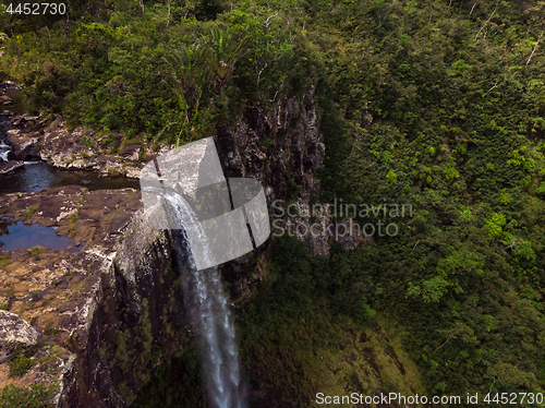 Image of Aerial top view perspective of amazing 500 feet tall waterfall in the tropical island jungle of Mauritius.