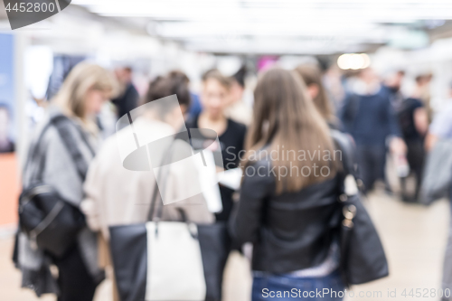 Image of Blured image of businesspeople networking and socializing during coffee break at business event.