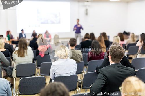 Image of Audience in lecture hall participating at business conference.