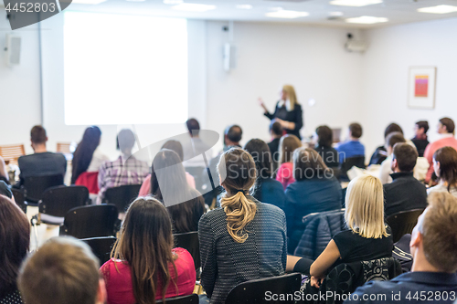 Image of Woman giving presentation on business conference workshop.