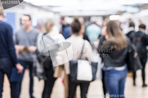 Image of Blured image of businesspeople networking and socializing during coffee break at business event.