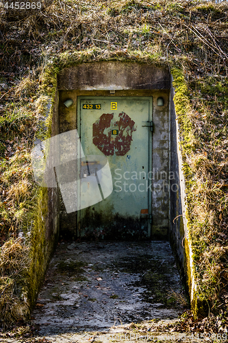 Image of Rusty door with a lock on a bunker