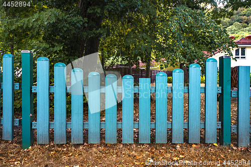 Image of Blue fence gate  at a yard in the fall