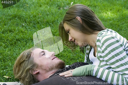 Image of Young couple hugging in a park