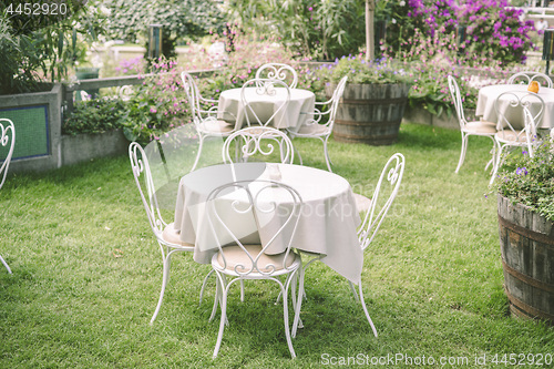 Image of Romantic garden setting with vintage furniture