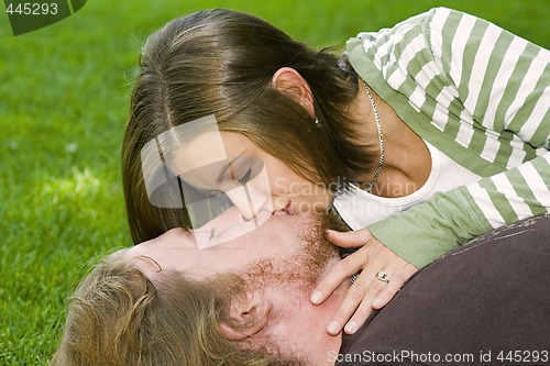 Image of Young couple kissing in the Park