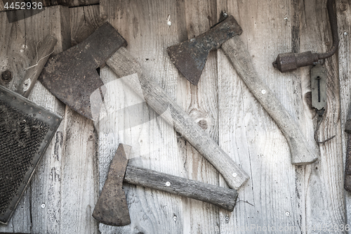 Image of Old axes hanging on a wall